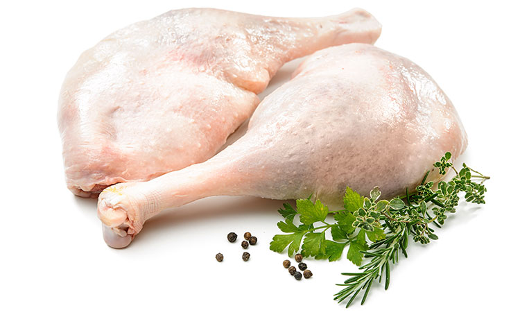 Two raw goose legs with some herbs