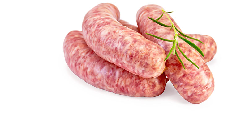 Four raw pork sausages piled on to each other